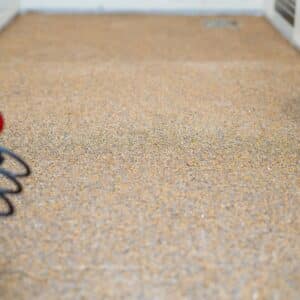 Yellowing epoxy flooring with visible fading and discoloration.