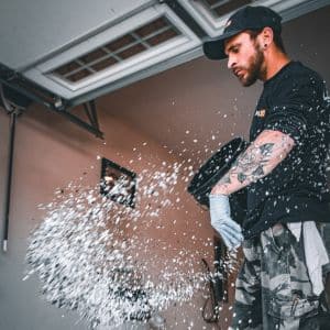 Level 10 Coatings worker casting flakes on freshly applied epoxy.