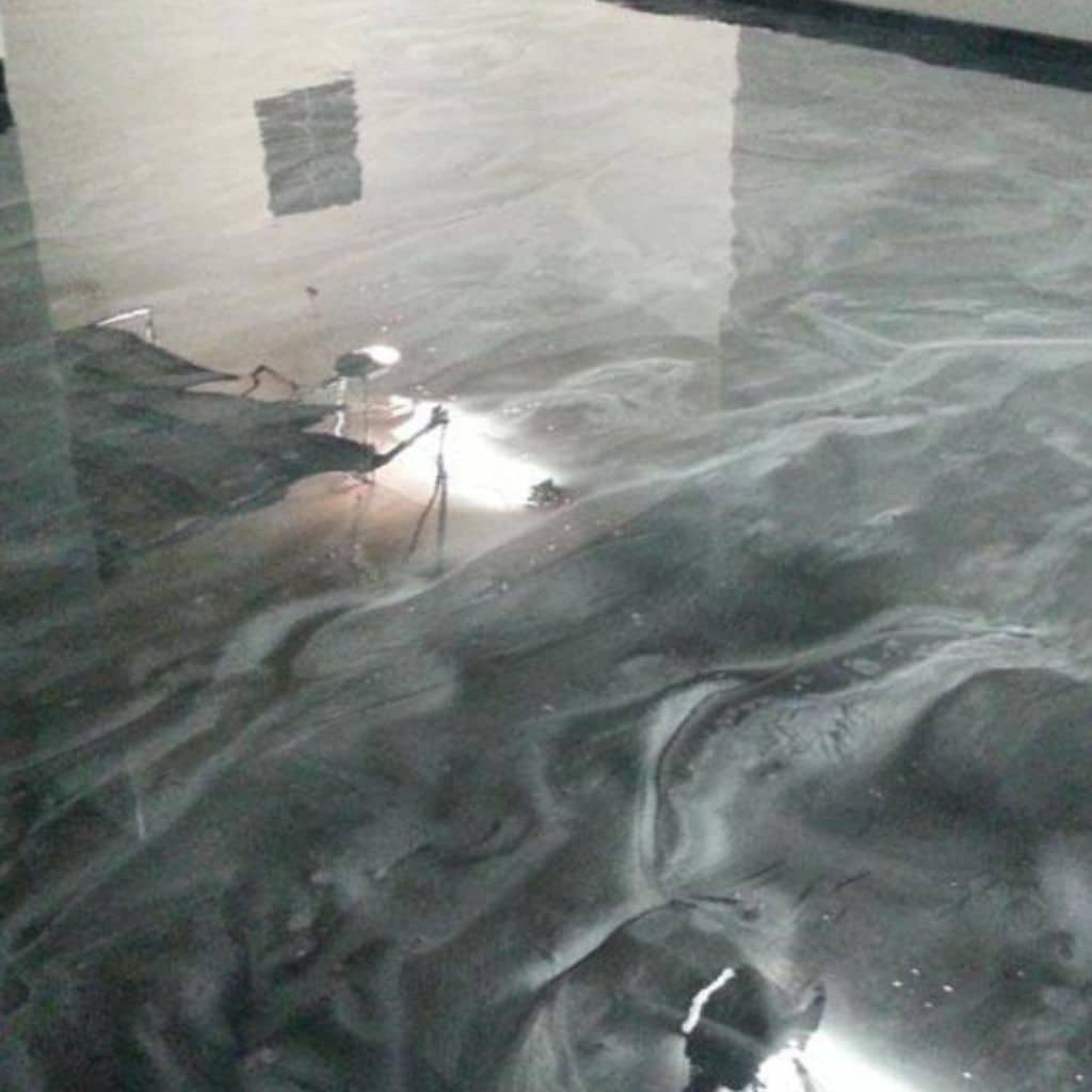 Shimmering dark green/blue polished concrete floor in a modern home.